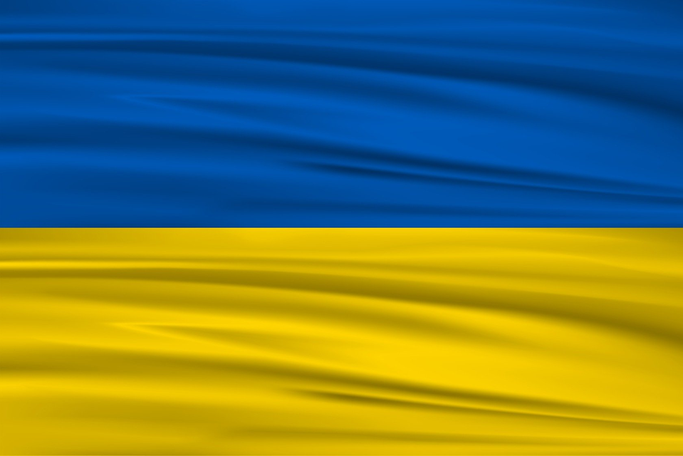 Närbild av den Ukrainska flaggan. Blått tyg högst upp och gult tyg längst ned